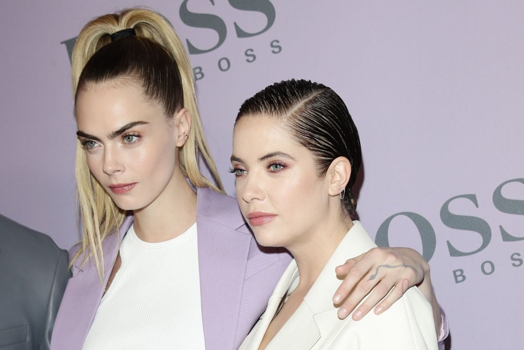 Cara Delevingne and Ashley Benson attend the BOSS fashion show on February 23, 2020 in Milan, Italy. 