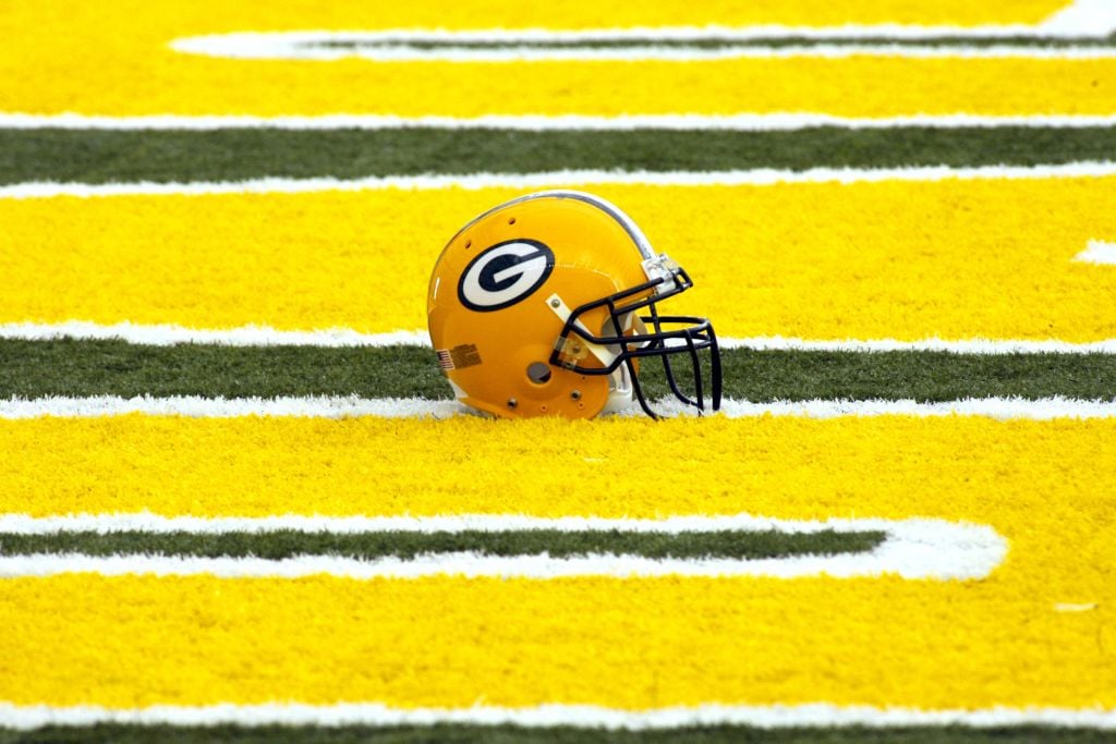 A Green Bay Packers helmet in an end zone 