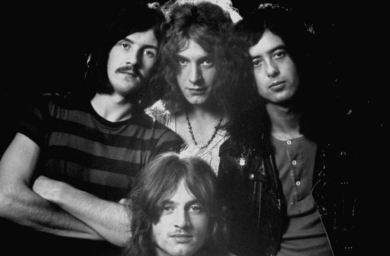 Drummer John Bonham, bassist/keyboardist John Paul Jones (seated), singer Robert Plant, and guitarist Jimmy Page of rock music group Led Zeppelin