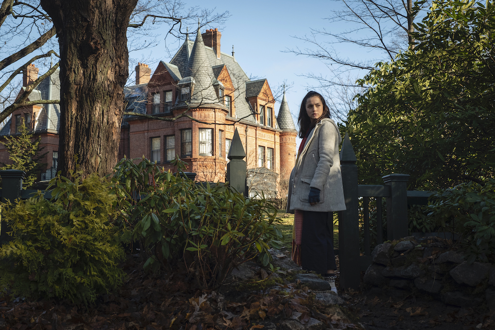 Marta in front of Harlan Thrombey's mansion, "helping" with the murder case in 'Knives Out.'