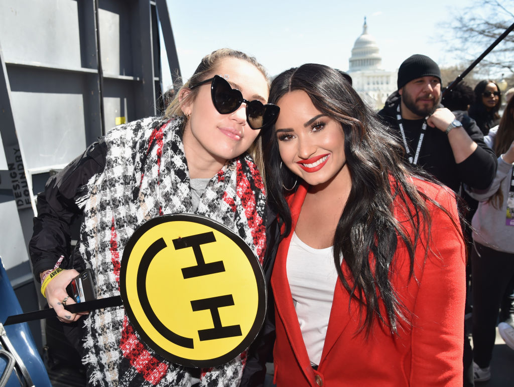Miley Cyrus and Demi Lovato attend March For Our Lives on March 24, 2018 in Washington, DC.
