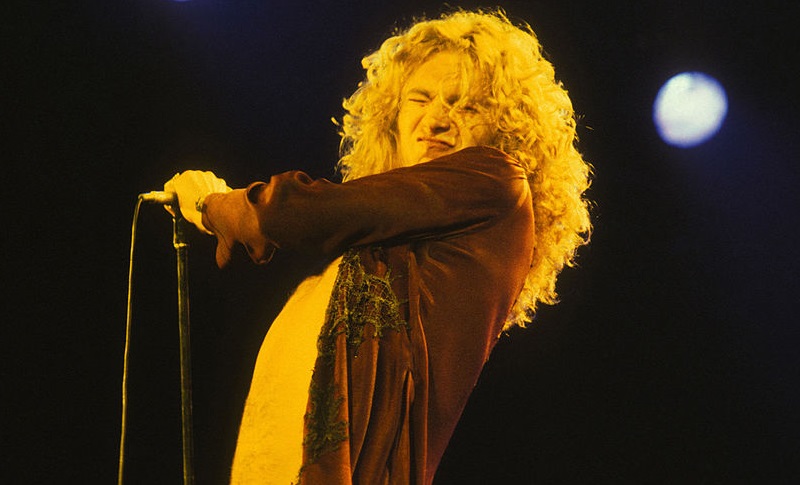 Robert Plant from Led Zeppelin holding a microphone
