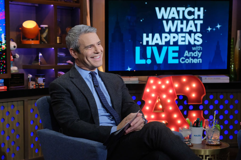 Andy Cohen smiling seated on his talk show