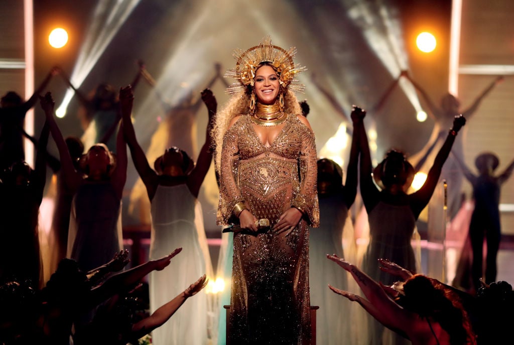 Beyoncé smiling on stage with a crown