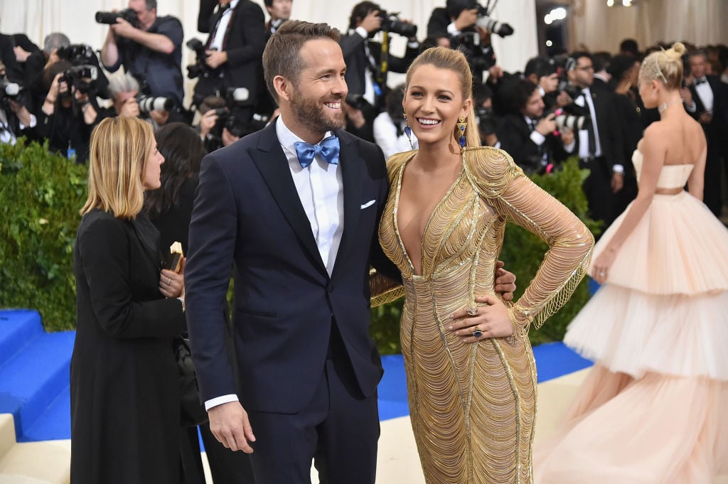 Ryan Reynolds and Blake Lively laughing on a red carpet