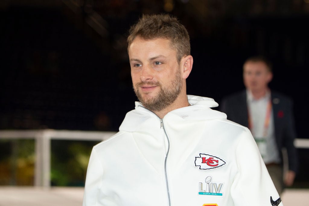 Dustin Colquitt smiling in a white zip up sweatshirt