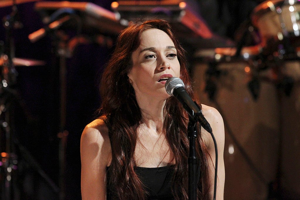 Fiona Apple singing, seated