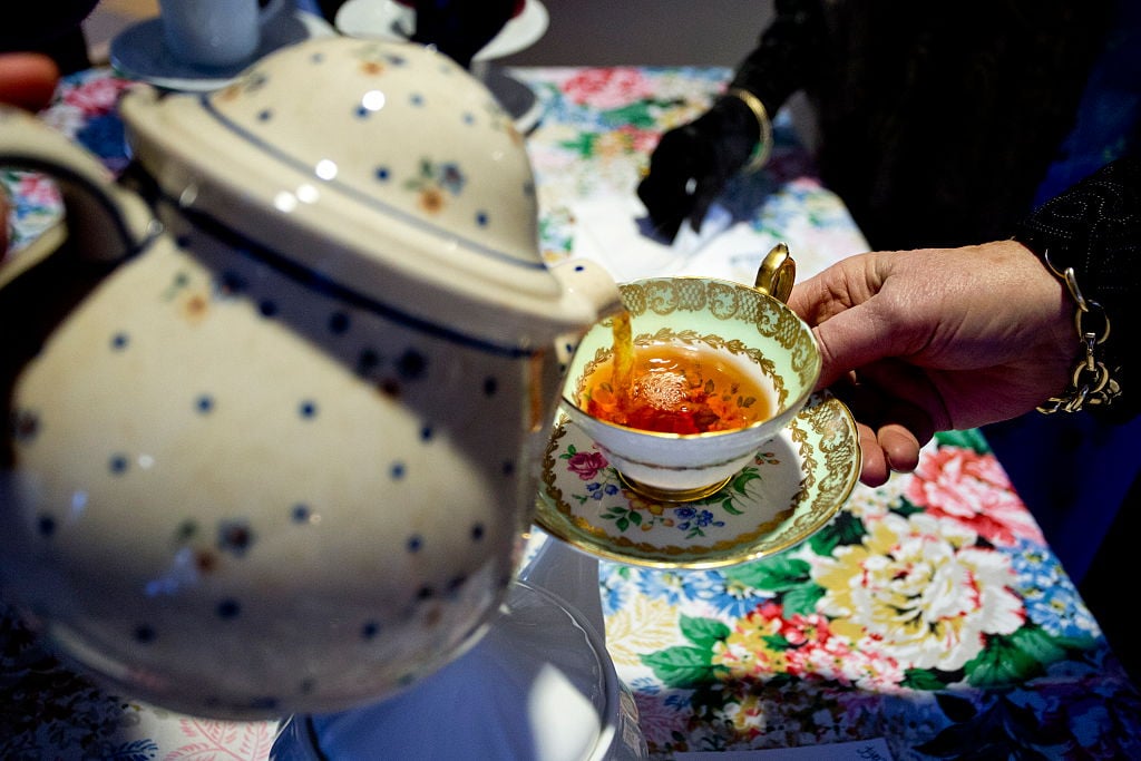 A tea cup is filled at a 'Downton Abbey' themed party