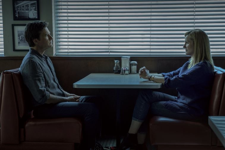 Jason Bateman and Laura Linney staring at each other in a diner