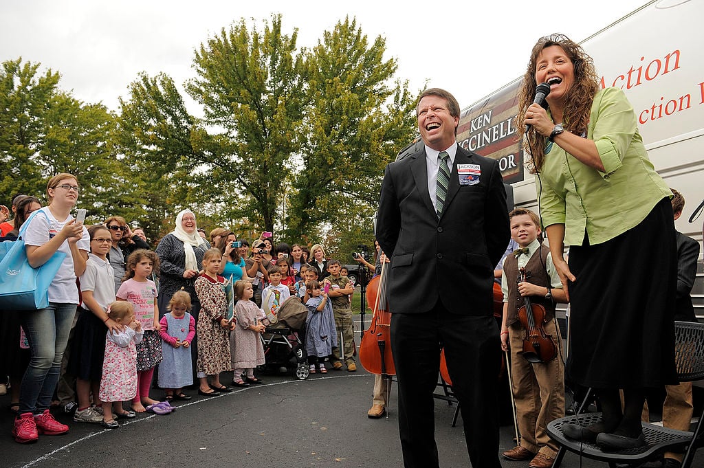 Jim Bob Duggar, center, and his wife, Michelle Duggar, make a stop on their 'Values Bus Tour' 
