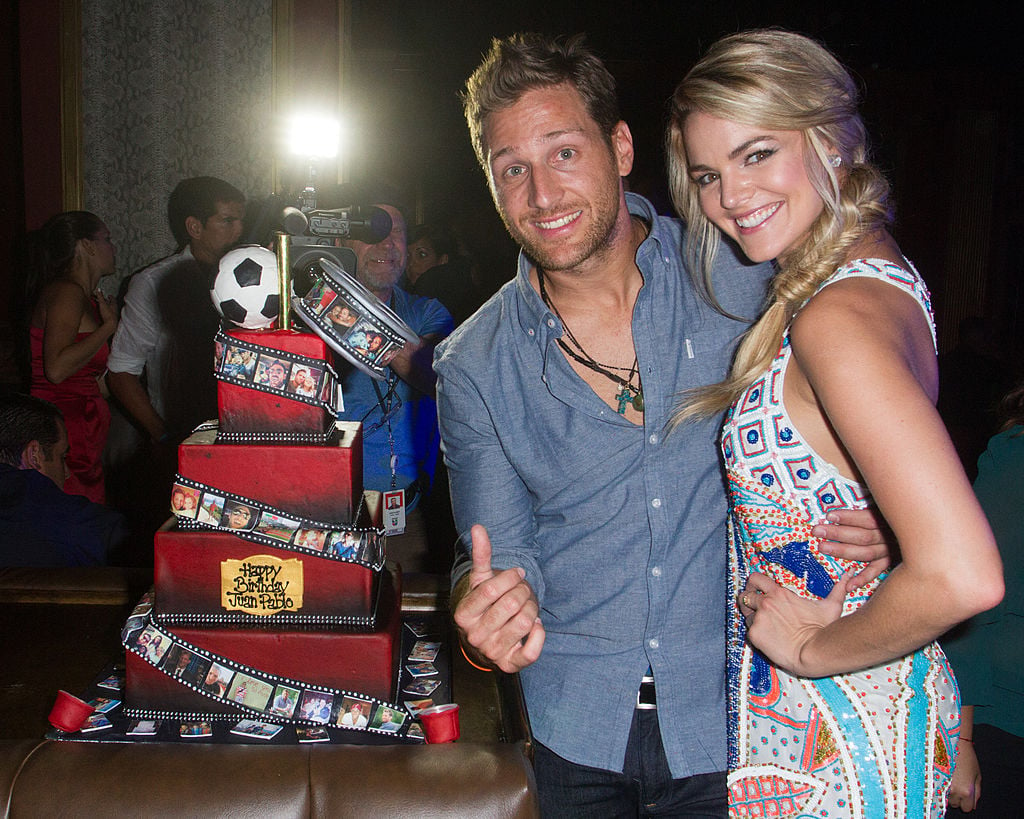 Juan Pablo Galavis and Nikki Ferrell pose with his birthday cake at Juan Pablo Galavis' birthday bash party