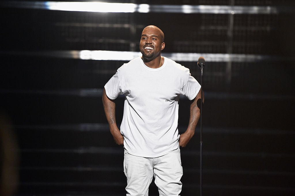 Kanye West smiling on stage