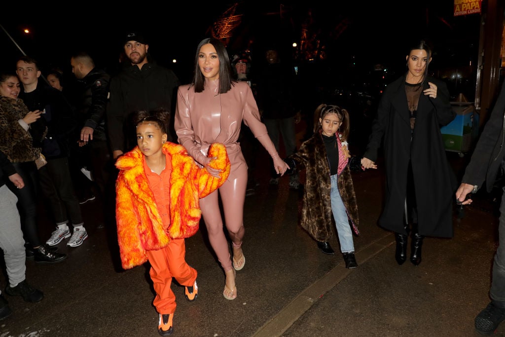 Kim Kardashian, North West, Penelope Disick and Kourtney Kardashian outside in a crowd