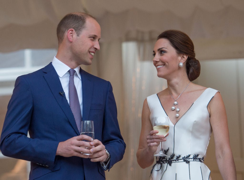 Kate Middleton and Prince William holding drinks 