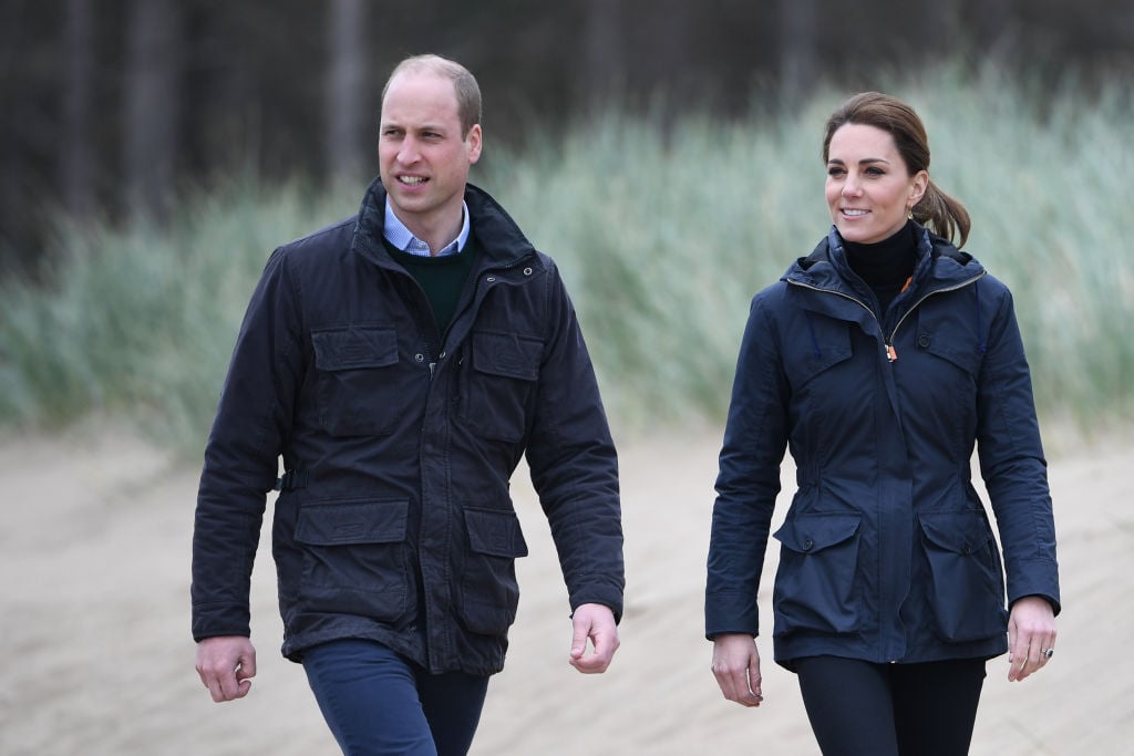 Kate Middleton and Prince William walk on a beach in 2019