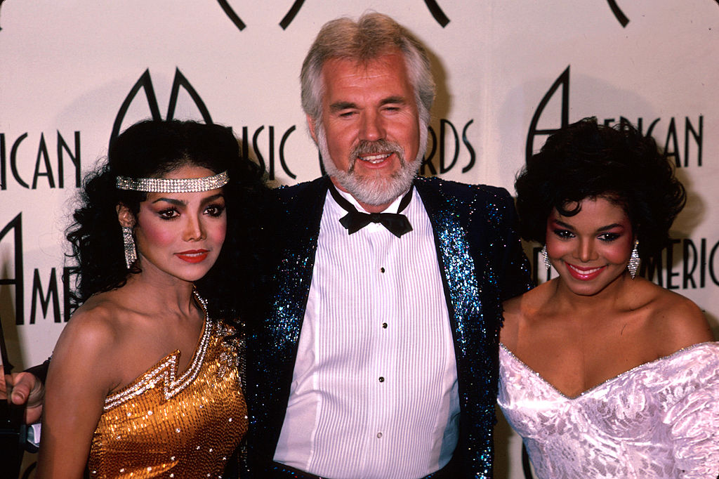 Kenny Rogers at the American Music Awards with Latoya Jackson and Janet Jackson |  Kevin Winter/DMI/The LIFE Picture Collection via Getty Images