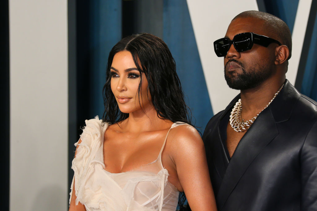 Kim Kardashian West and Kanye West smiling, looking away from the camera