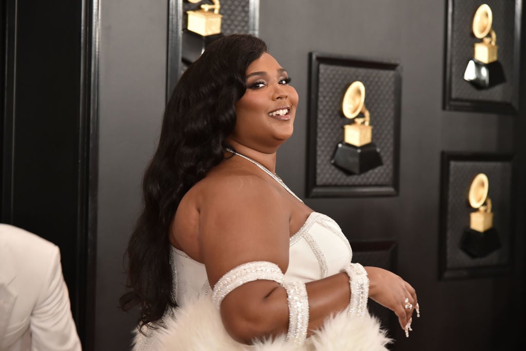 Lizzo smiling, turned to the side