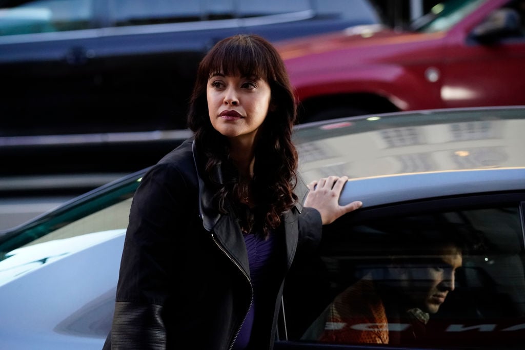 Marisa Ramirez standing next to a car on set of 'Blue Bloods'