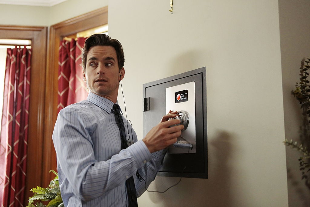 Matt Bomer as Neal Caffrey in 'White Collar' trying to unlock a safe