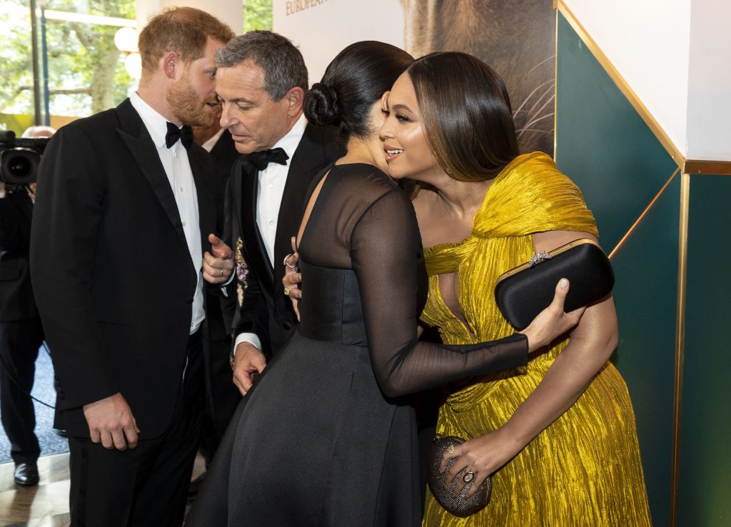Britain's Prince Harry, Duke of Sussex with Disney CEO Robert Iger as Britain's Meghan, Duchess of Sussex embraces US singer-songwriter Beyoncé