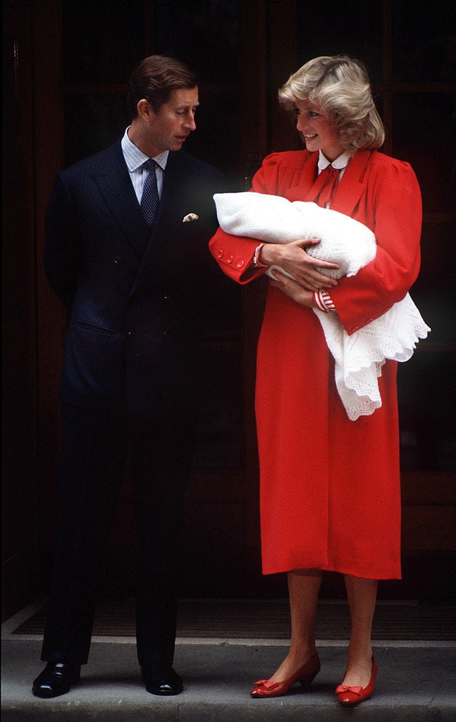 Prince Charles and Princess Diana holding Prince Harry