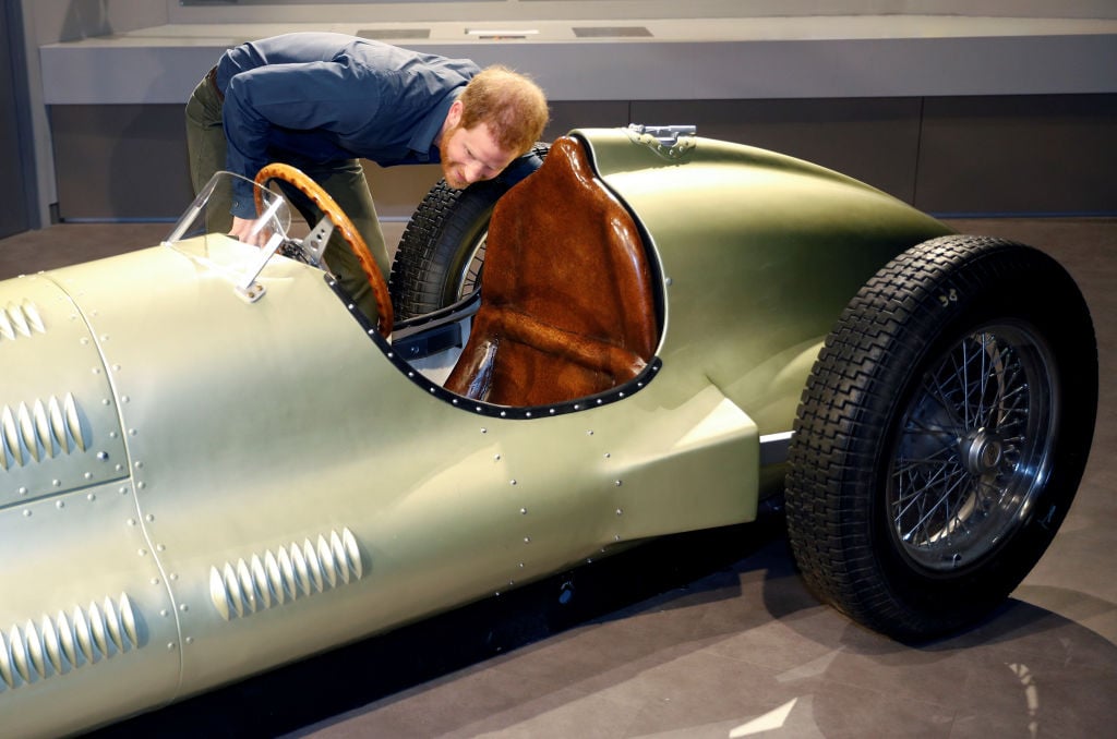 Prince Harry looking at a vintage car