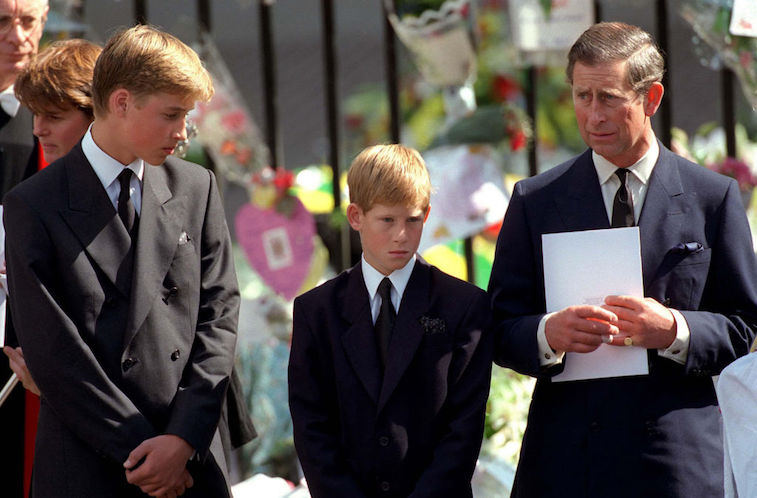 Prince William, Prince Harry, and Prince Charles stand together at Princess Diana's funeral in 1997