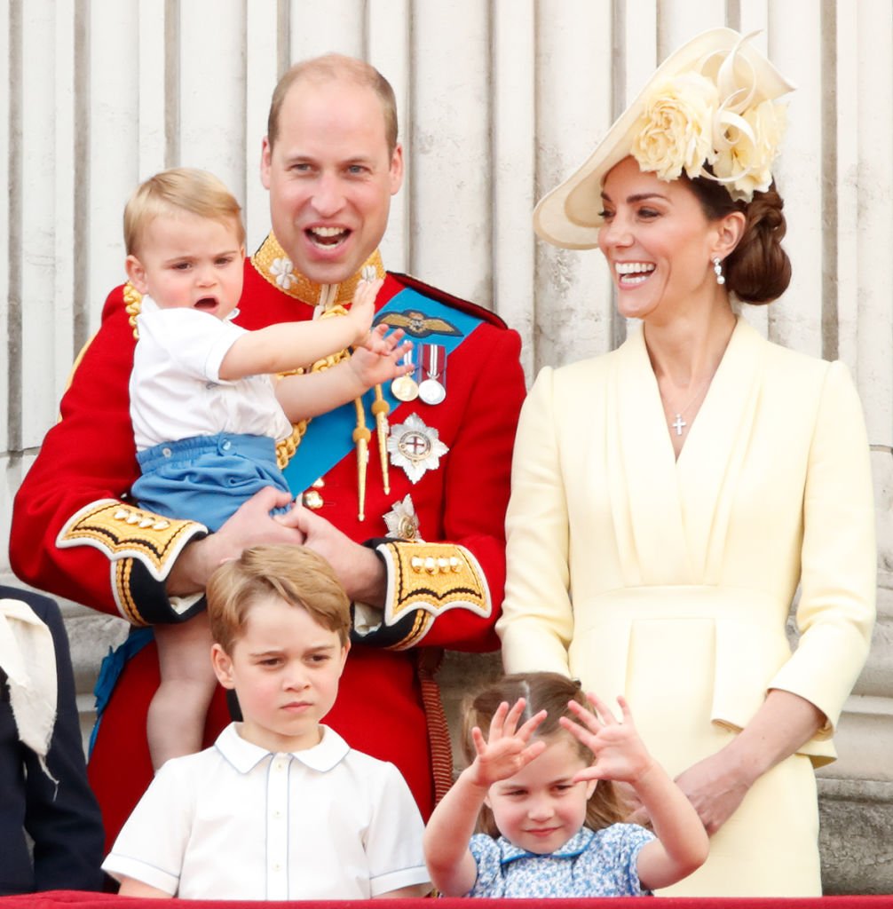 Prince William holding Prince Louis, Kate Middleton, Prince George, and Princess Charlotte