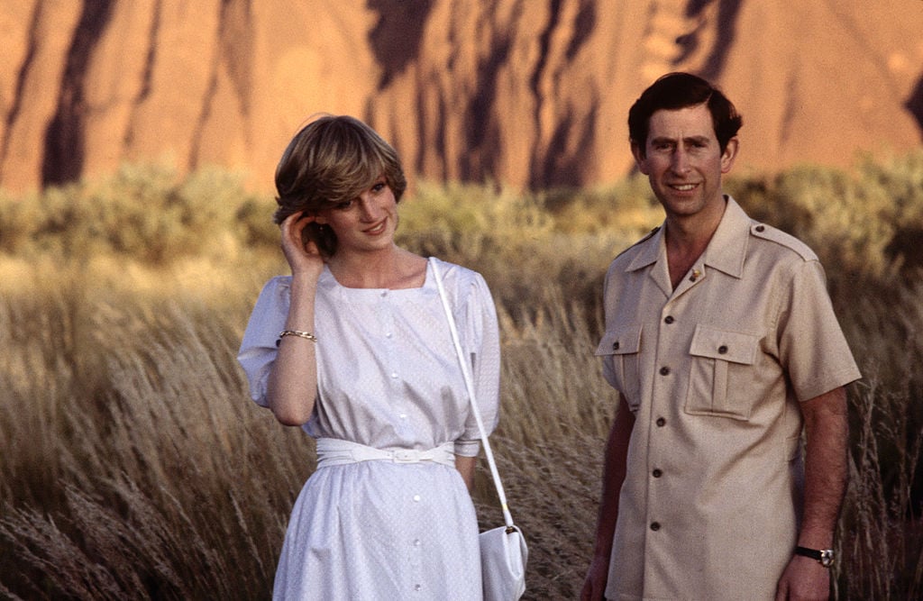 Diana Princess of Wales and Prince Charles pose in front of Ayer's Rock on March 21, 1983 near Alice Springs, Australia during the Royal Tour of Australia. Diana wore a dress designed by Benny Ong