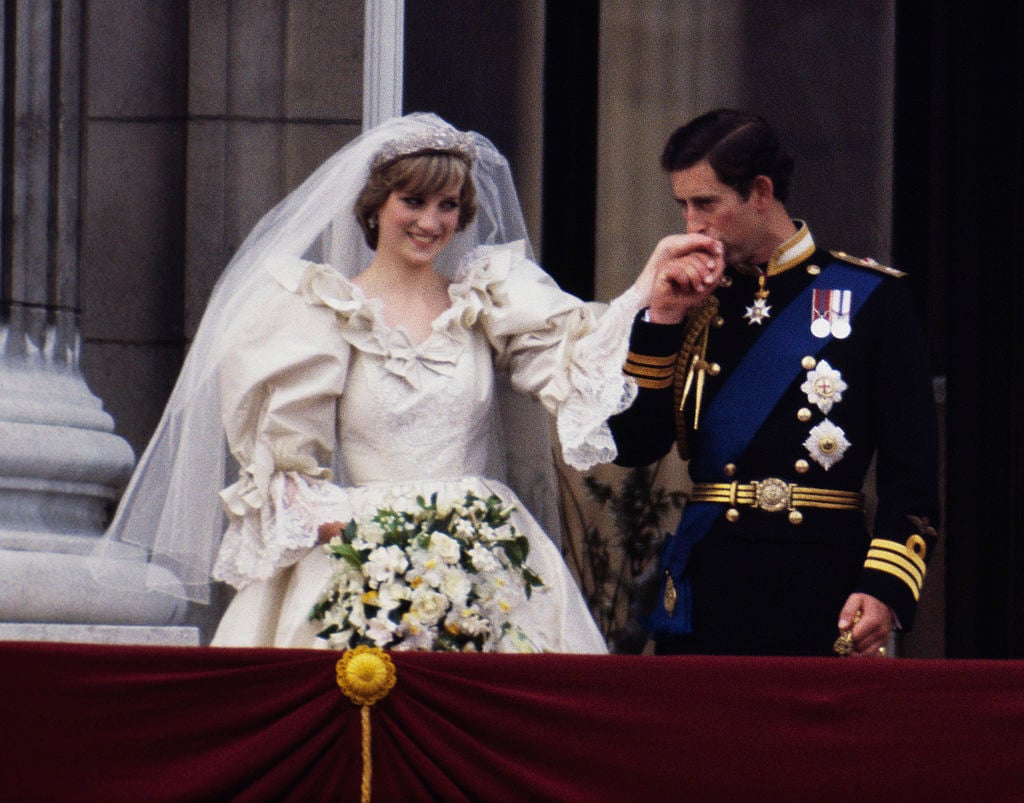 The Prince and Princess of Wales on the balcony of Buckingham Palace on their wedding day, 29th July 1981. She wears a wedding dress by David and Elizabeth Emmanuel and the Spencer family tiara