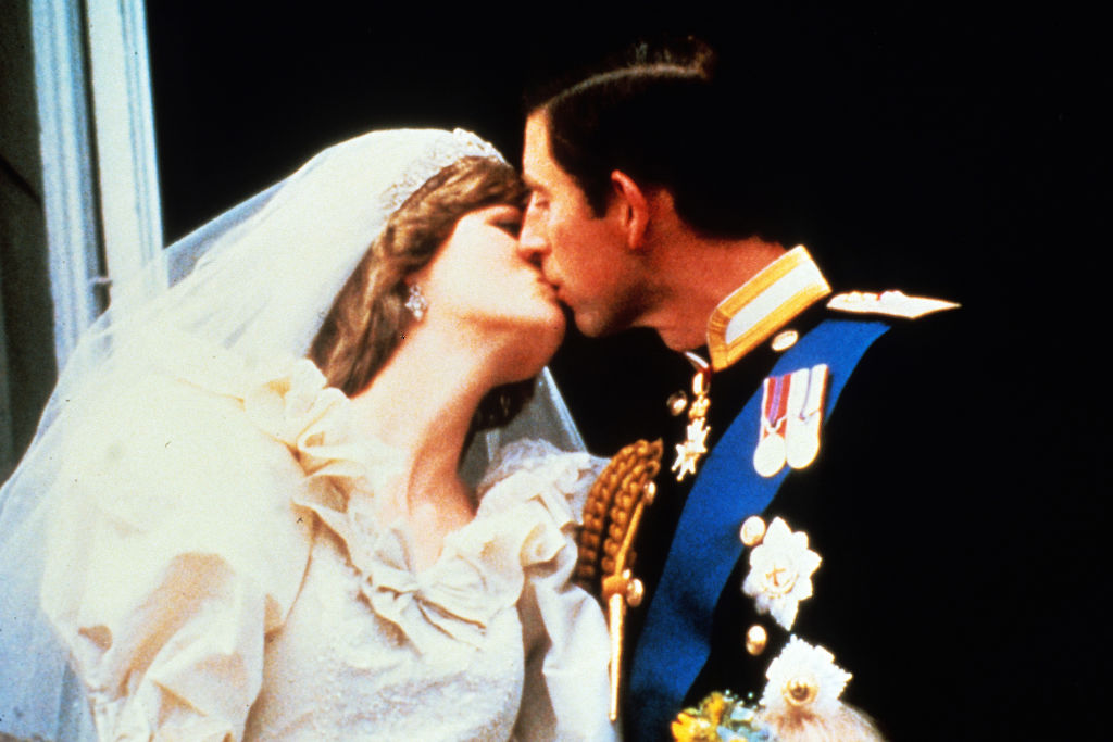 Princess Diana and Prince Charles kissing on  balcony