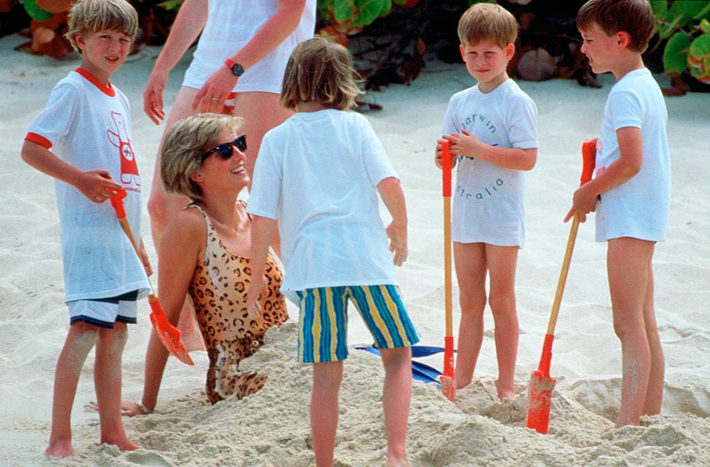 Princess Diana gets buried in sand by her sons, Prince Harry and Prince William, while on vacation