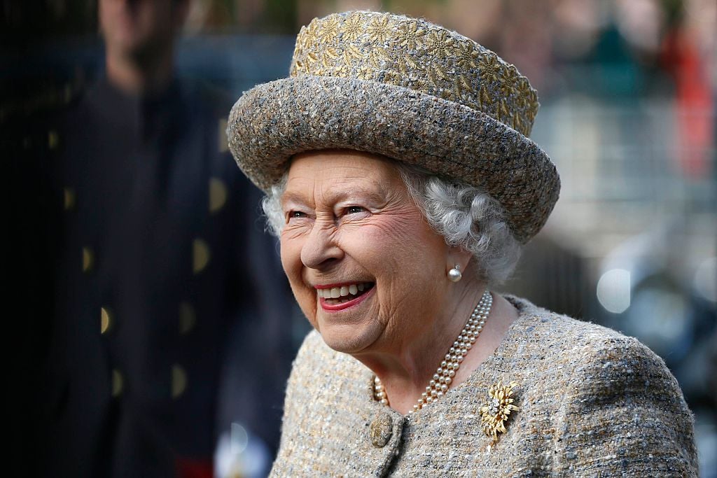 Queen Elizabeth II smiling, looking away from the camera