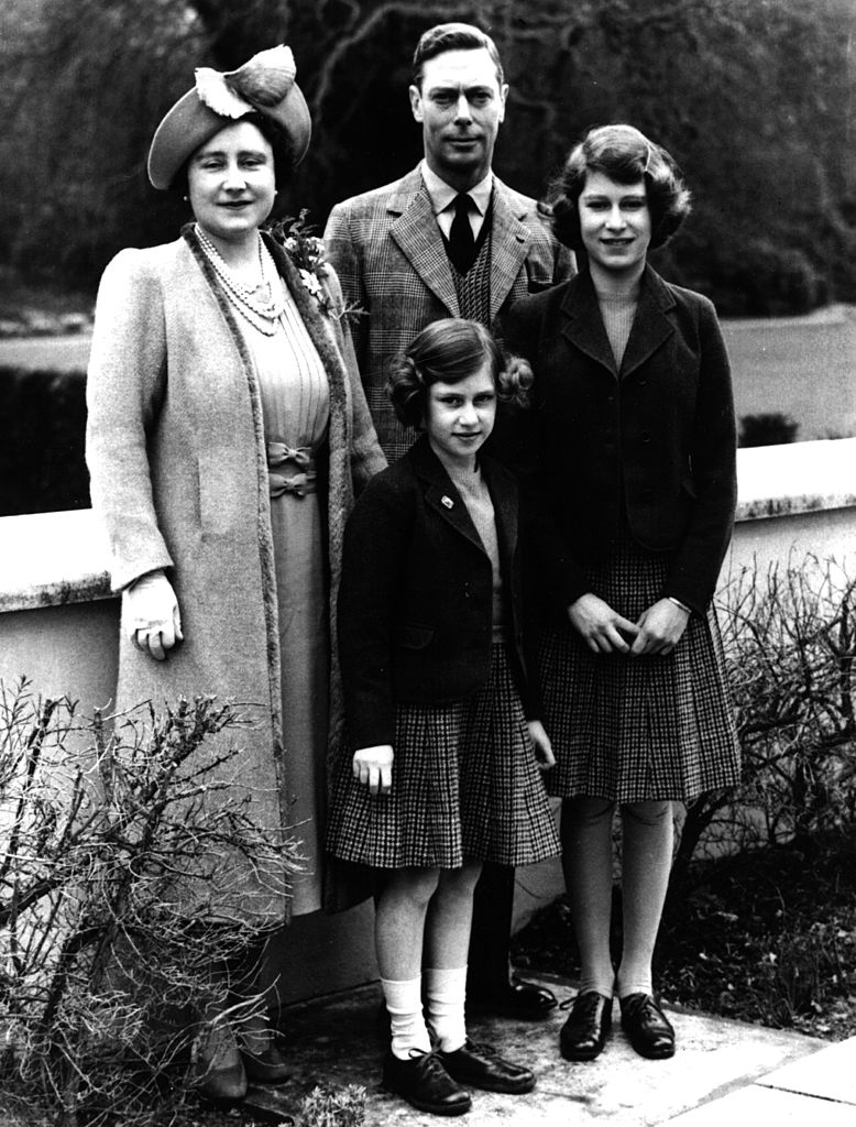 Queen Elizabeth II stands with her parents and her sister on her 14th birthday in 1940