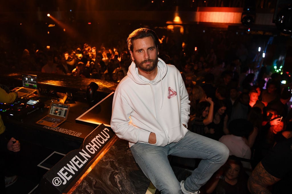 Scott Disick sitting down with his hands in his pockets