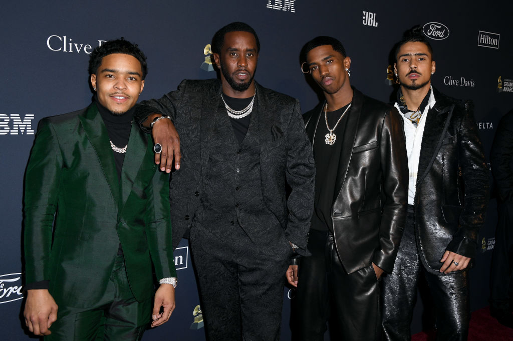 Justin Dior Combs, Honoree Sean "Diddy" Combs, Christian Casey Combs, and Quincy Taylor Brown in front of a repeating background