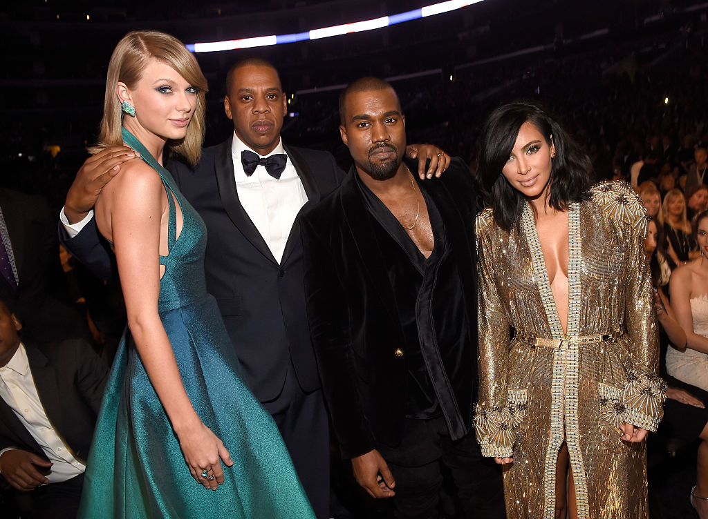 Taylor Swift, Jay-Z, Kanye West, Kim Kardashian West smiling at the camera in semi formal dress