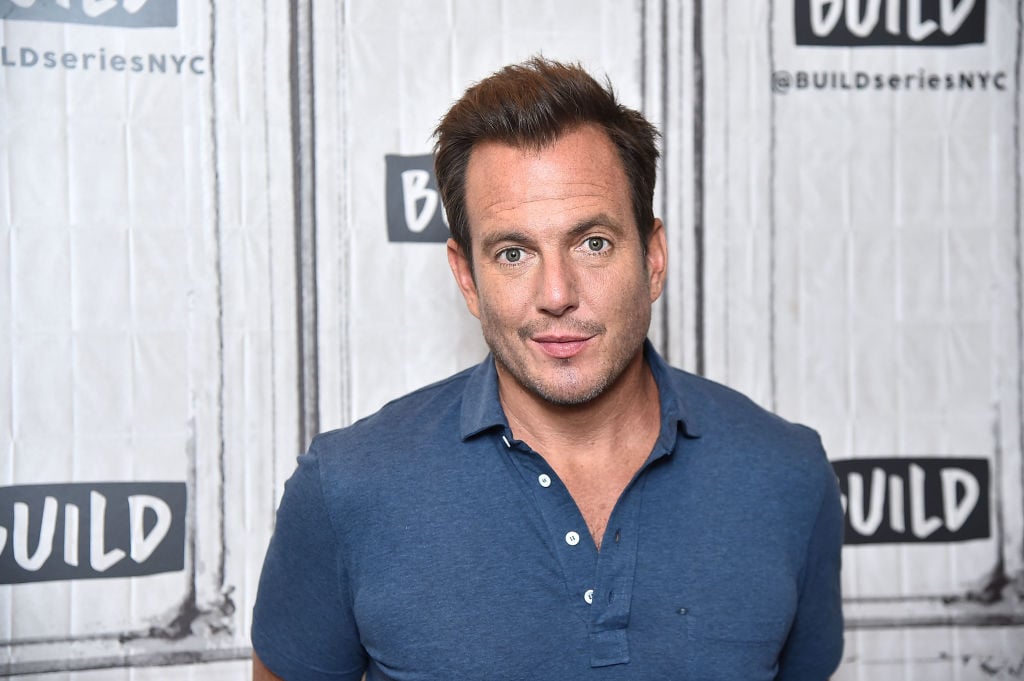 Will Arnett smiling in front of a repeating background
