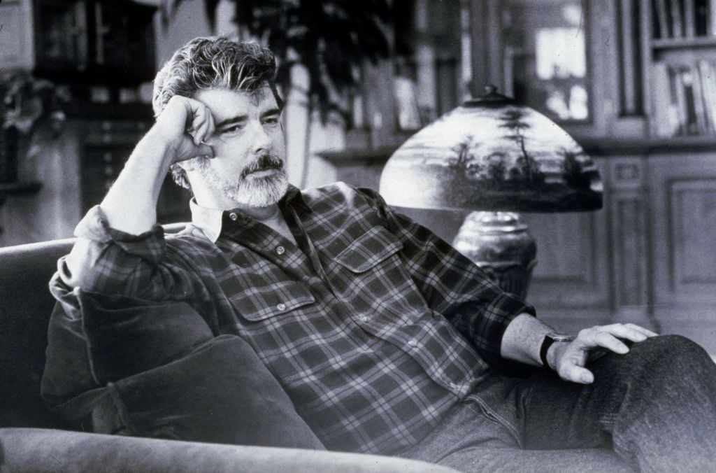 Star Wars creator George Lucas sitting by a lamp