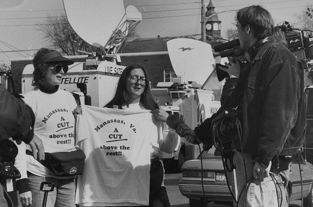 People sell t-shirts during John Bobbitt's trial