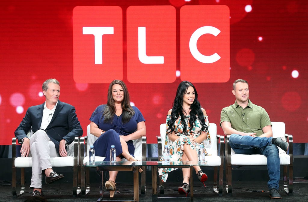 Matt Sharp, Molly Hopkins, Paola Mayfield, Russ Mayfield of the television show '90 Day Fiance' smiling on a stage