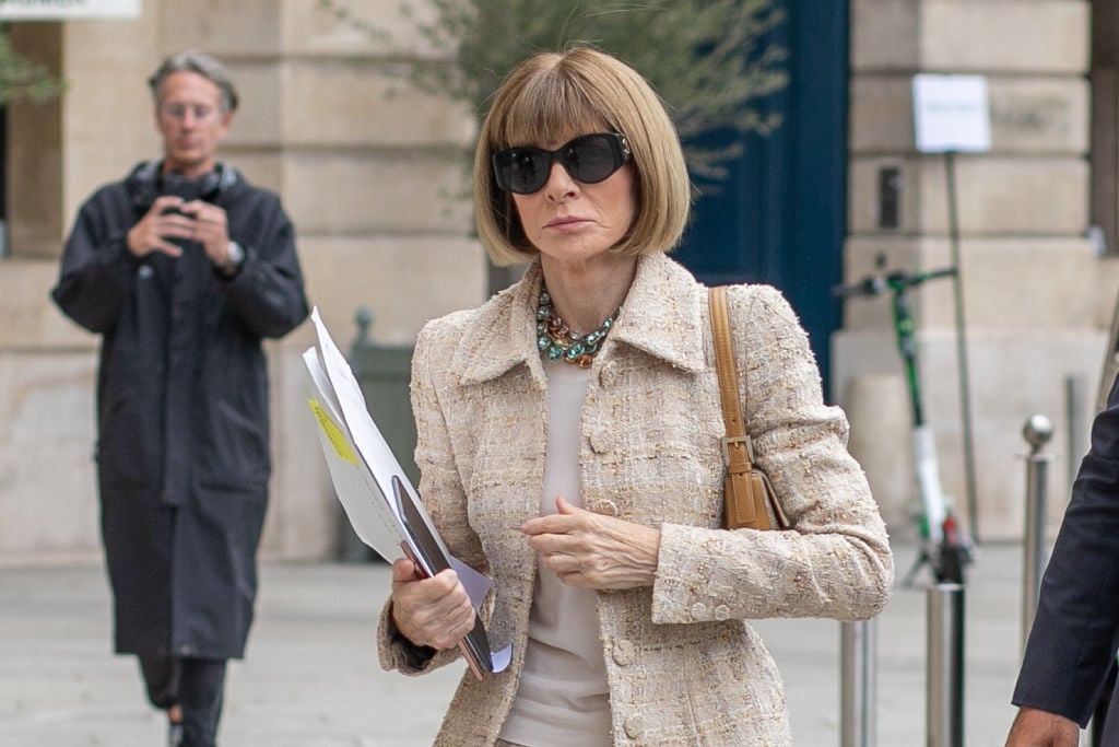 Anna Wintour wearing sunglasses and an oatmeal colored blazer