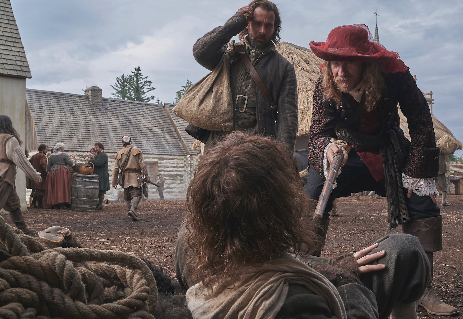 Trepagny (David Thewlis) taps Duquet (James Bloor) with his walking stick as Sel (Christian Cooke) looks on