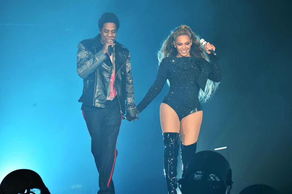 Beyonce and Jay-Z on stage holding hands while performing