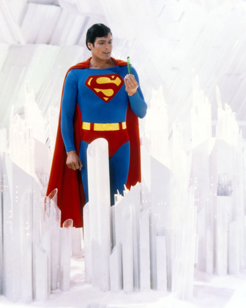 Superman, played by American actor Christopher Reeve (1952 - 2004), holds a green crystal at the Fortress of Solitude, in a promotional still from 'Superman' (1978)