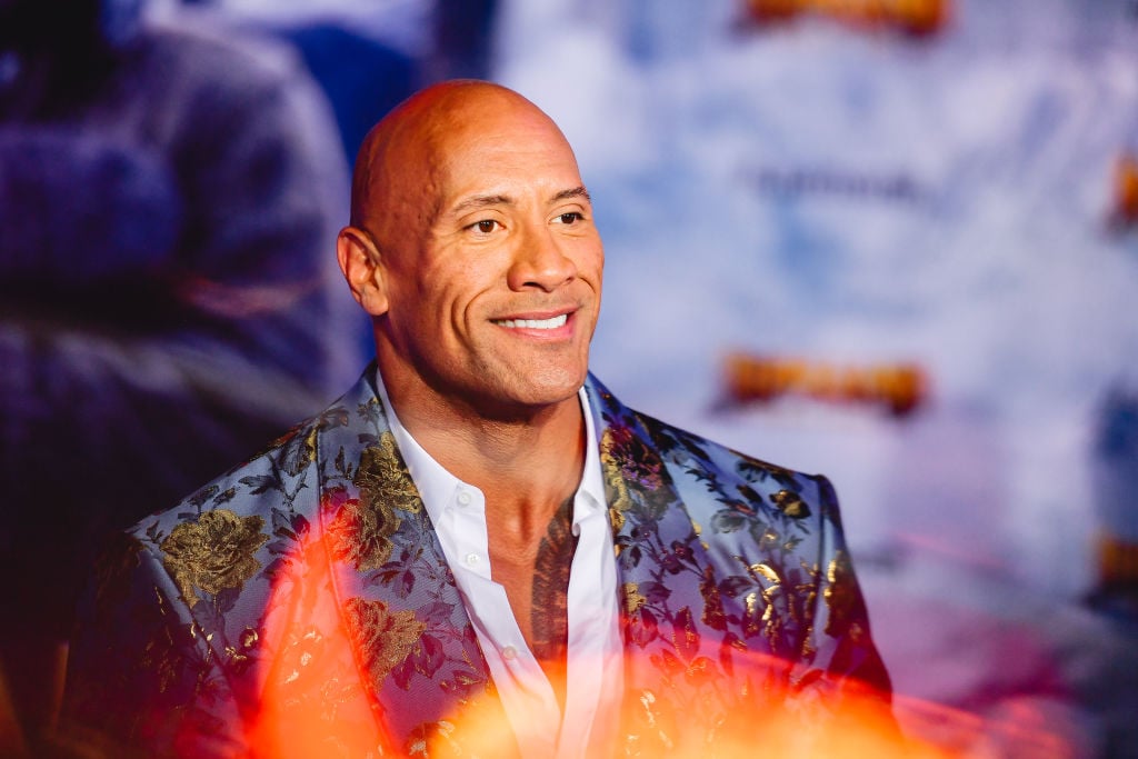 Dwayne 'The Rock' Johnson smiling, turned to the right