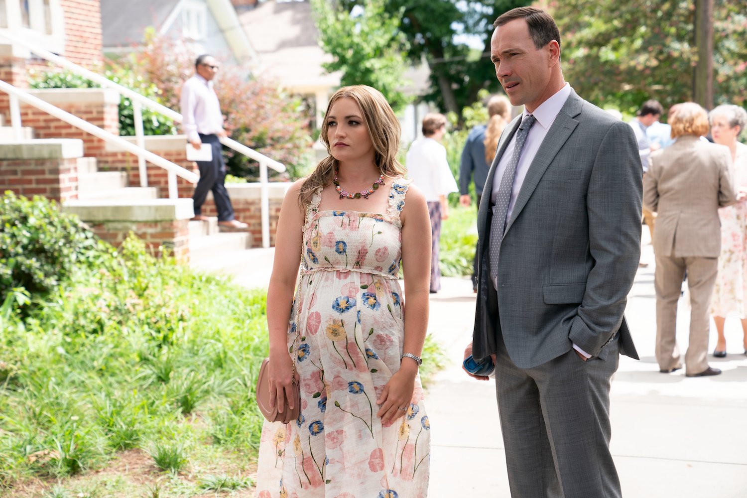 Pregnant Noreen standing next to Bill outside a church in Sweet Magnolias 