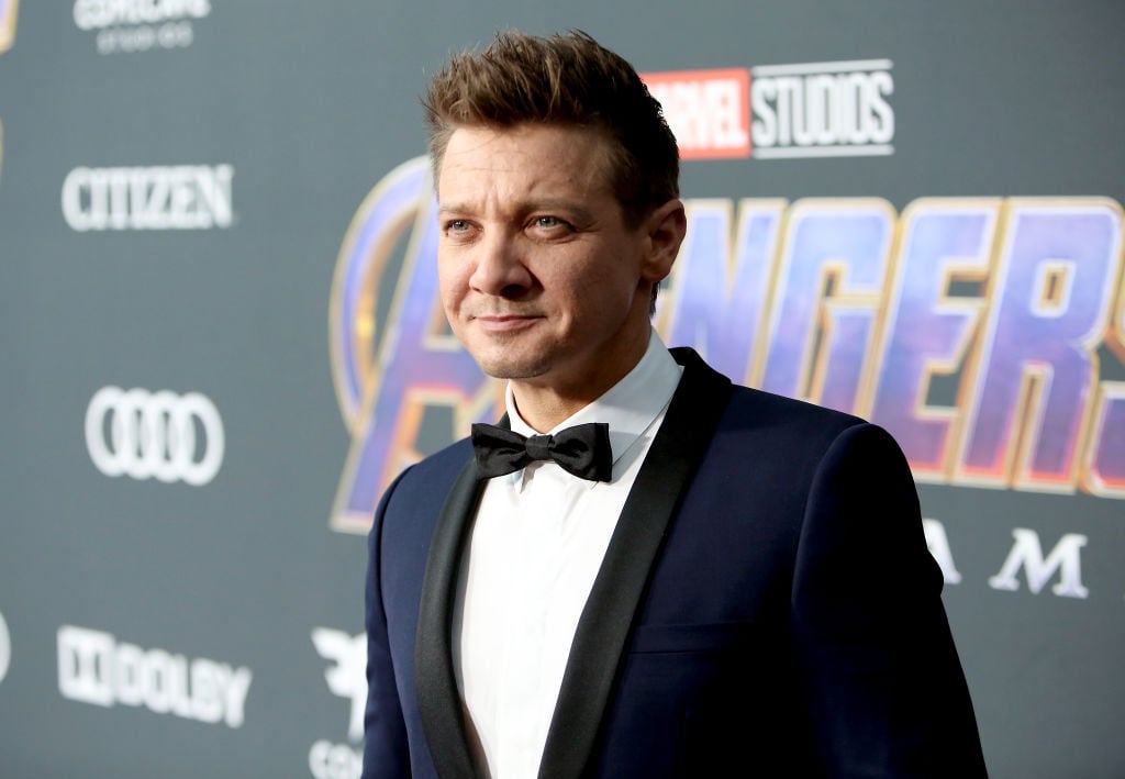 Jeremy Renner smiling, looking off camera