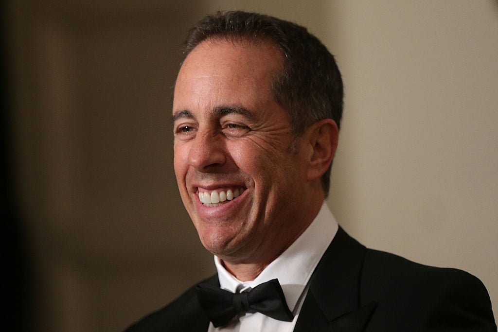 Jerry Seinfeld laughing in a tuxedo